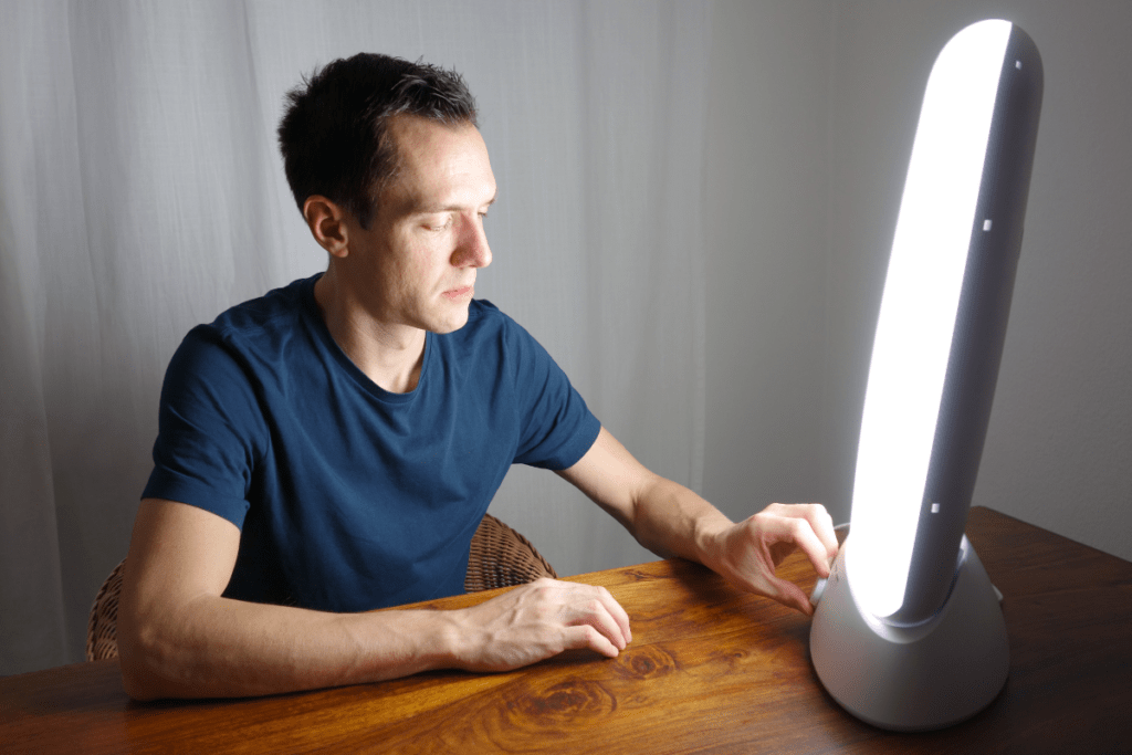 Using Your Lightbox: A man sitting at a table looking at a light.